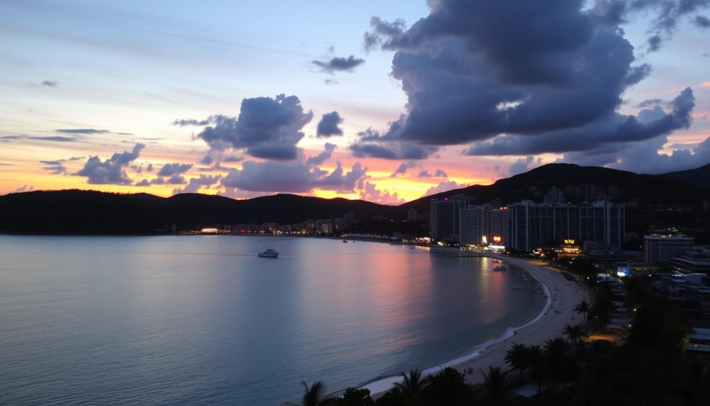 Sunset view over Patong Bay with nightlife areas beginning to light up Sunset over Patong Bay